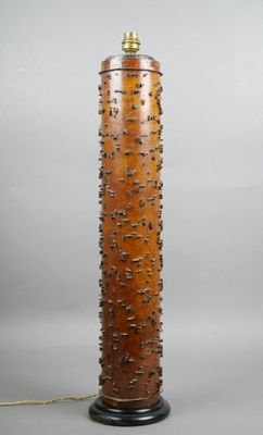 an image of a tall wooden lamp on a table