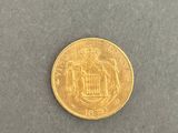 a close up of a gold coin on a gray surface