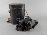 an old pair of binoculars sitting on top of a table