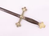 a sword with a cross on it on a white surface