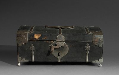 a metal trunk with a lock on it on a gray surface