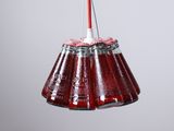 a red and white hanging light with a red cord