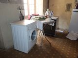 an image of a kitchen with a washer and dryer in it