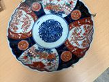 a blue and white plate on a table in a room