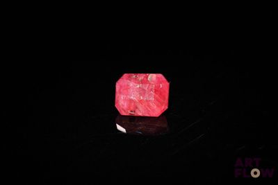 a pink stone in the dark with a black background