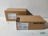 two boxes with labels on them sitting on a white surface