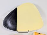 a black and yellow plate with a black and white plate with a yellow and black plate with a black and white plate with a yellow and white plate