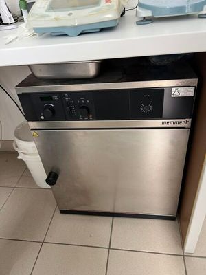a silver dishwasher sitting on top of a kitchen counter