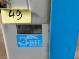 a blue and white machine with a yellow sticker on it