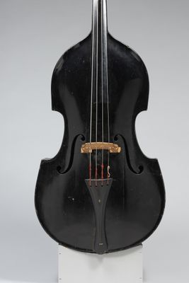 a black violin sitting on top of a white stand