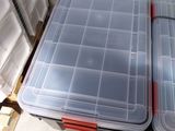 two plastic containers sitting on top of a pallet