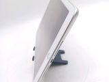 a tablet computer sitting on a stand on a white surface