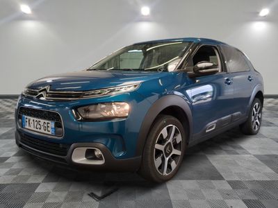 the blue citrole is parked on a checkered floor