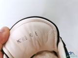 a person holding a pair of shoes with writing on them