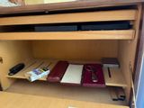 a desk with a drawer and a phone on top of it