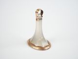 silver and gold plated bell on a white surface with a white background