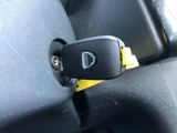 a car key that is attached to the seat belt of a car