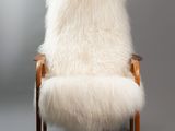 an image of a chair with a white fur on it