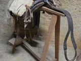une selle de cheval posée sur un support en bois