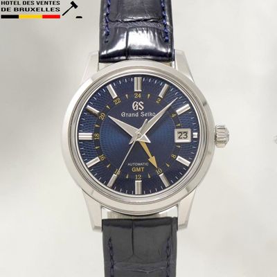 an image of a close up of a wrist watch with a blue dial
