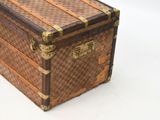 a brown and tan trunk sitting on top of a white table