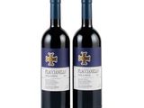 two bottles of red wine sitting next to each other on a white surface
