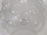a clear glass vase with a decorative design on it