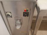 a small stainless steel refrigerator in the corner of a kitchen