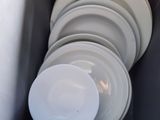 a lot of plates that are in a container