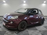 a picture of a maroon smart car in a showroom
