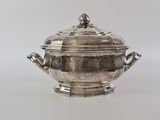 an antique silverplated soup tureene with a lid and handles