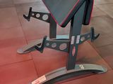 a bench in the middle of a gym with a red floor