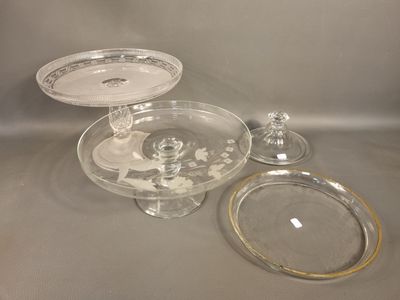 two plates and a glass cake stand on a table