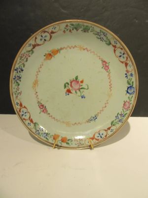 a plate with a floral design on it on a table