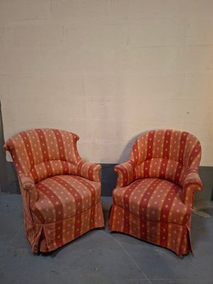 two chairs sitting next to each other in a room