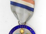 an image of a medal with a world map on it