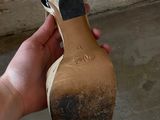 a person holding a pair of shoes in their hand