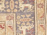 a close up of a rug with a blue and red design on it