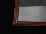 a mirror hanging on the wall in a bathroom