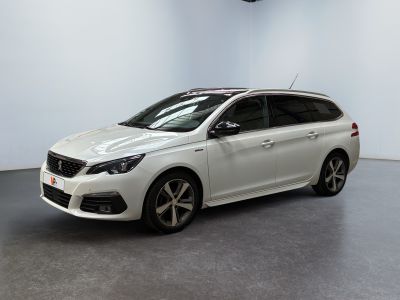 a white car is parked in a white room with a black floor
