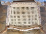 a wooden chair with a wicker seat on a wooden floor