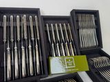 a lot of silverware in a box on the table