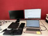 deux ordinateurs portables et un ordinateur de bureau posés sur un bureau