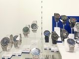a lot of watches on display in a glass case