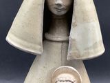 an image of a statue of a woman holding a baby