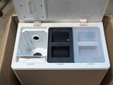 a white cooler sitting inside of a box on the floor