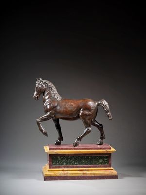 bronze statue of a horse on a pedestal with a black background