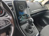 a car dashboard with a cell phone in the center of it