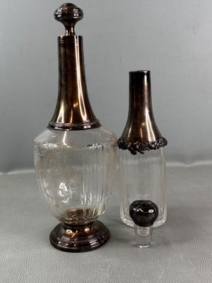 two glass vases sitting next to each other on a table