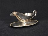 a silver plate with a saucer and saucer on it